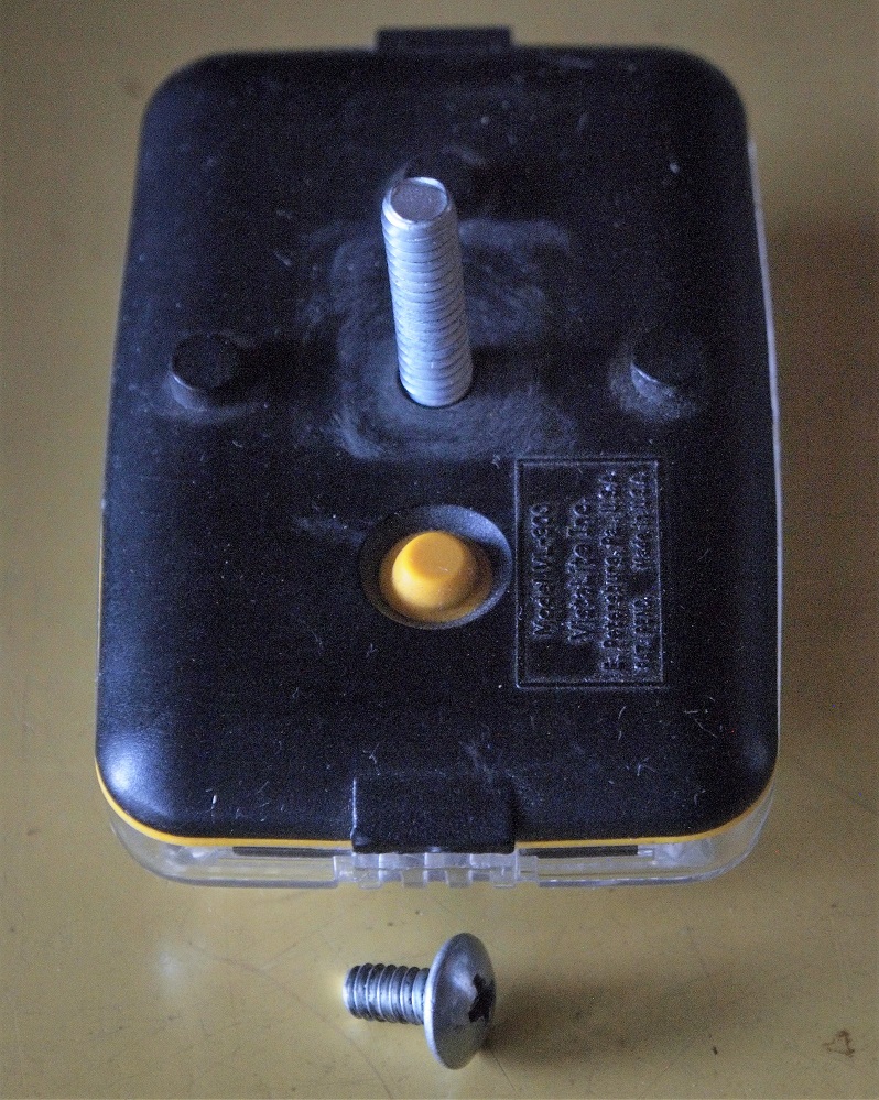 Original external bracket-mount screw shown next to light with standoff-length screw installed
