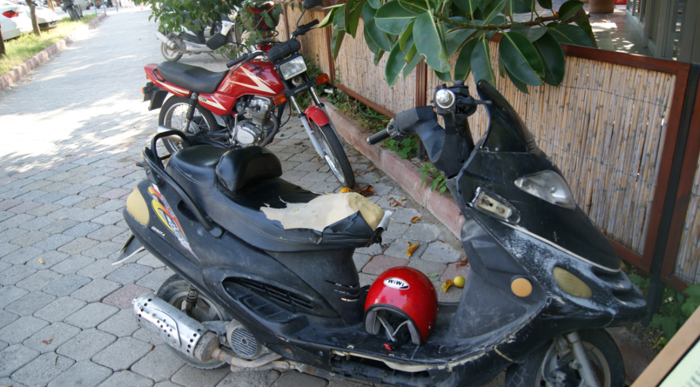 Chinese scooter looking sun burnt and abused.PNG